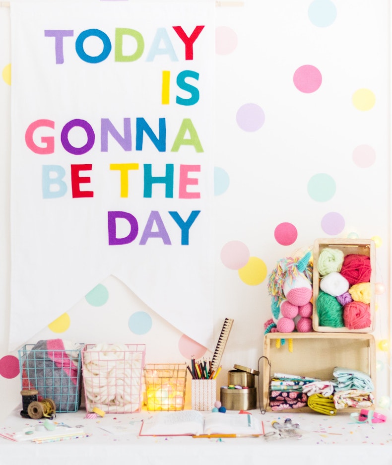 A bright tablescape with Today is gonna be the day letters above and fun crafting materials at Cheerfully Given