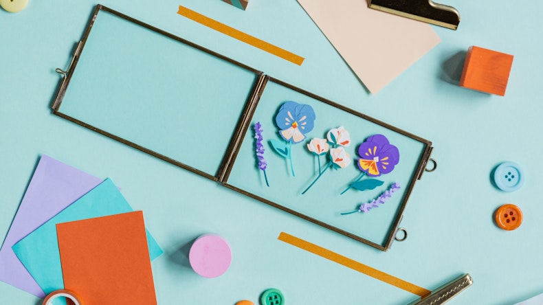 Glass frame lies open with cut paper flowers for Papercut Illustration Workshops at Cheerfully Given