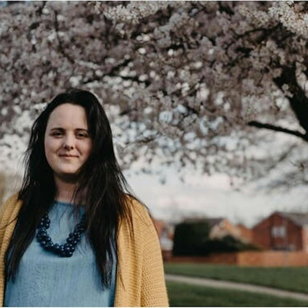 Hannah Allwright stands under cherry blossom | Creative Bea @ Cheerfully Given