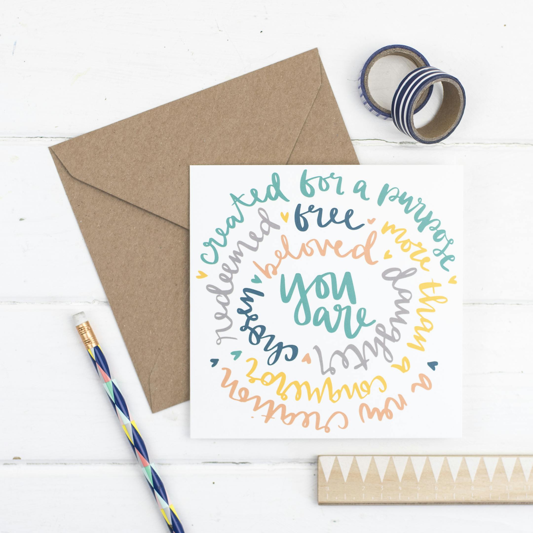 A spiral of words around 'You Are' in various colours speaking of our Identity in Christ | by Hope and Ginger