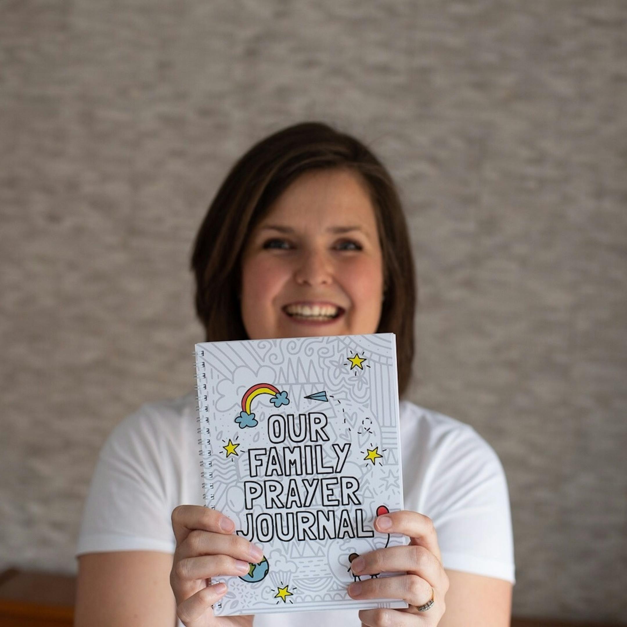 Cath Sales holding spiral bound Our Family Prayer Journal | Made by Hope and Ginger @ Cheerfully Given