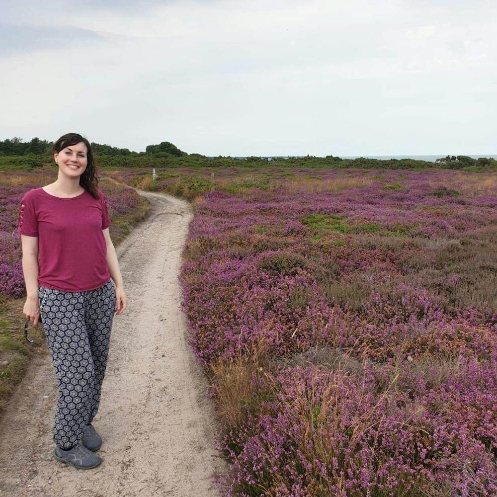 Sharon White stands on a heather moorland | Sharon White Designs | Cheerfully Given
