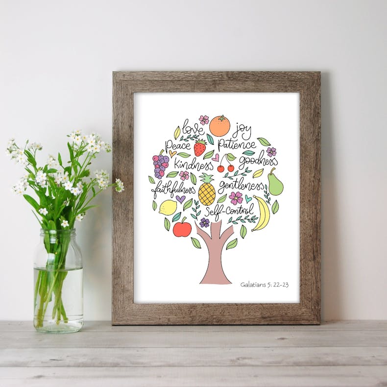 A Christian Print of a Tree filled with the Fruit of the Spirit words and various fruits on a white background by Sharon White Designs @ Cheerfully Given